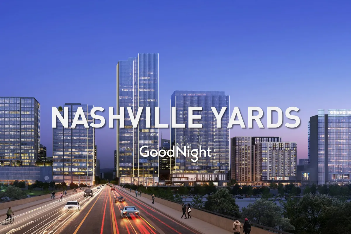 A dynamic cityscape featuring modern skyscrapers, a busy roadway, and the Nashville Yards signage, representing the vibrant business district. The scene buzzes with energy, hinting at proximity to OneCity’s business hub and the broader downtown area.
