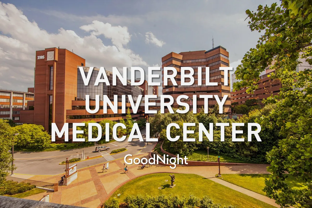 A contemporary exterior view of Vanderbilt University Medical Center, showcasing its modern building, landscaped plaza, and leafy greenery. The scene conveys a professional, welcoming environment, emphasizing convenience and accessibility for visiting guests.
